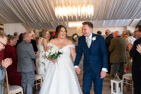 smiling wedding couple walking down the aisle after their wedding at the BArn at Willerby