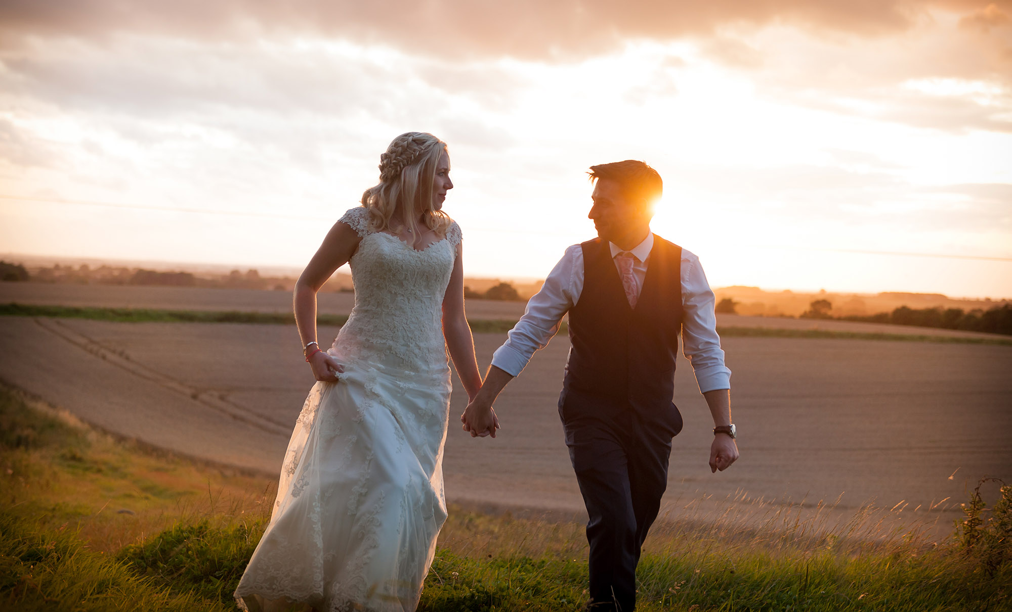 romantic wedding couple holding hands at sunset - east yorkshire wedding photographer